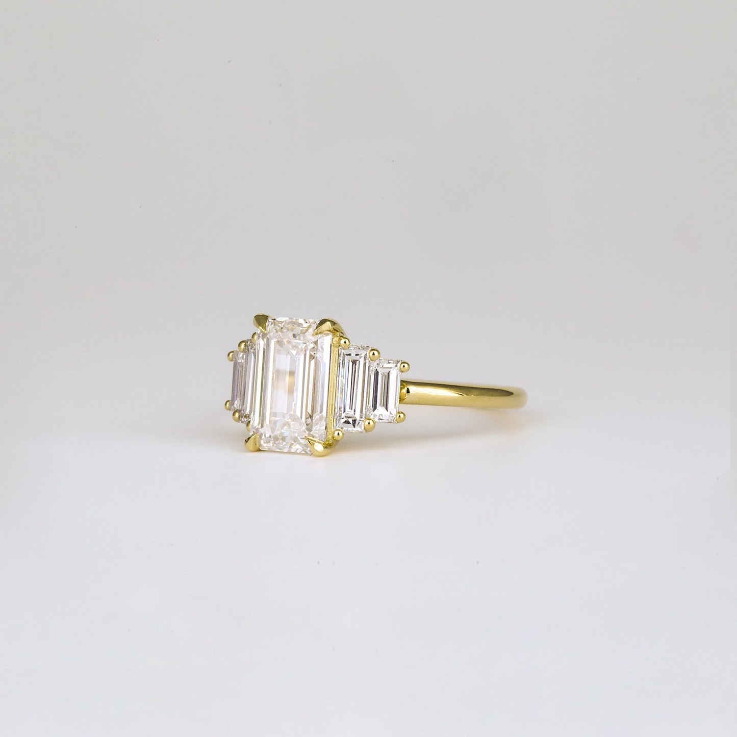 Five Stone Emerald Lab Diamond Graduated Gold Ring